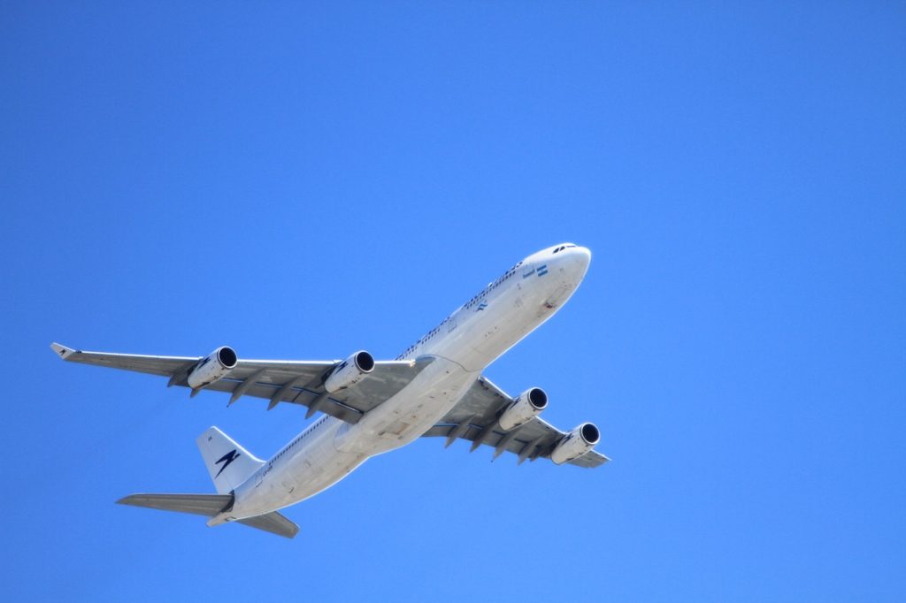 Plane flying through clear sky.